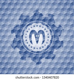 goat head icon inside blue emblem or badge with abstract geometric polygonal pattern background.
