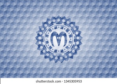goat head icon inside blue badge with geometric pattern.