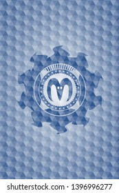 goat head icon inside blue emblem with geometric background.