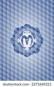 goat head icon inside blue badge with geometric pattern. 