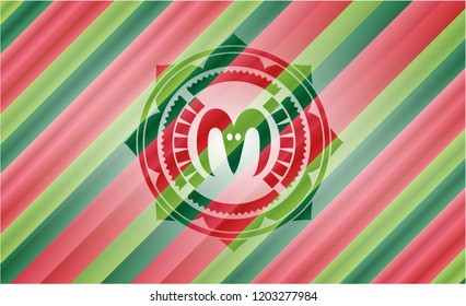 goat head icon inside christmas emblem.
