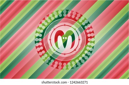 goat head icon inside christmas colors badge.