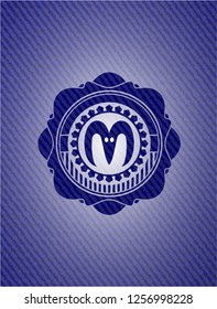 goat head icon inside emblem with jean background