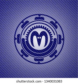 goat head icon inside emblem with denim texture