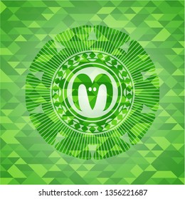goat head icon inside green emblem with mosaic ecological style background
