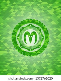 goat head icon inside green emblem with mosaic background