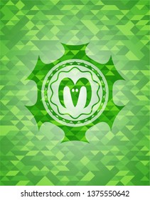goat head icon inside green emblem with mosaic ecological style background
