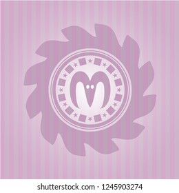 goat head icon inside pink emblem