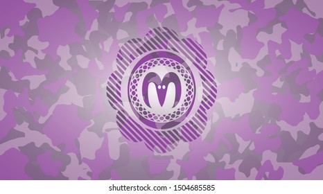 goat head icon inside pink and purple camouflaged emblem