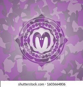 goat head icon inside pink and purple camouflage texture