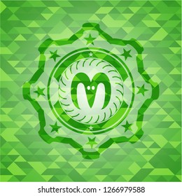 goat head icon inside realistic green emblem. Mosaic background