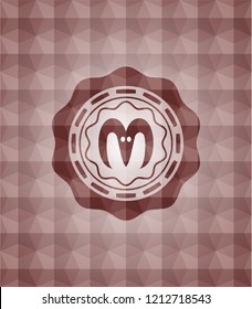 goat head icon inside red seamless emblem or badge with abstract geometric pattern background.