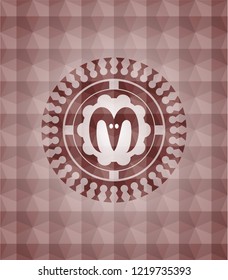 goat head icon inside red seamless emblem or badge with geometric pattern background.