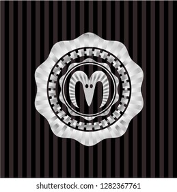 goat head icon inside silvery emblem or badge