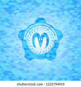 goat head icon inside sky blue mosaic emblem