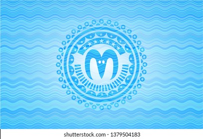 goat head icon inside sky blue water style emblem.