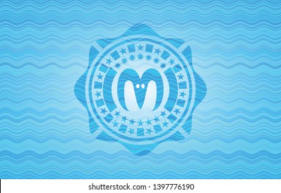 goat head icon inside sky blue water style badge.