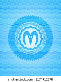 goat head icon inside water wave style emblem.