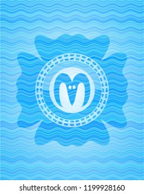 goat head icon inside water wave badge.