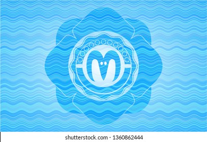 goat head icon inside water wave style emblem.