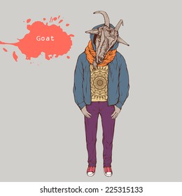 goat standing dressed in clothes cocked his head looking forward holding hands in pockets against the background paint splatter