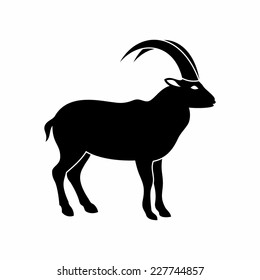 goat symbol with a black profile silhouette of a long horned goat for use as a design element for agriculture astrology or Chinese mythology and calendar