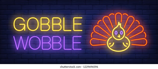 Gobble wobble neon text with turkey. Thanksgiving Day advertisement design. Night bright neon sign, colorful billboard, light banner. Vector illustration in neon style.