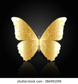 Gold abstract butterfly with floral pattern on black background with reflection.