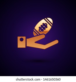 Gold American Football ball on hand icon isolated on dark blue background. Rugby ball icon. Team sport game symbol.  Vector Illustration