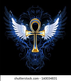 Gold ankh with white wings on dark blue patterned background.