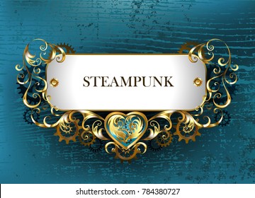 Gold antique jewelry Steampunk nameplate with brass gears on turquoise wooden background. 