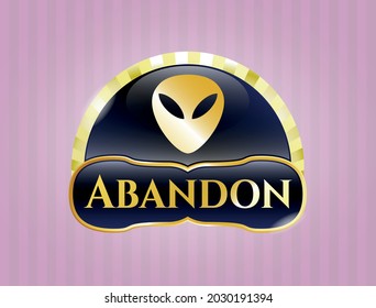 Gold badge or emblem with alien icon and Abandon text inside