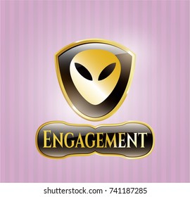  Gold badge or emblem with alien icon and Engagement text inside