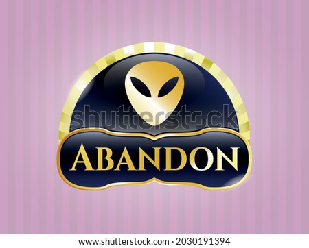 Gold badge or emblem with alien icon and Abandon text inside