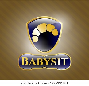  Gold badge or emblem with croissant icon and Babysit text inside