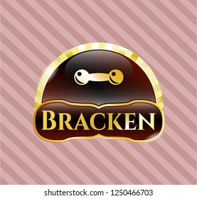  Gold badge or emblem with dumbbell icon and Bracken text inside
