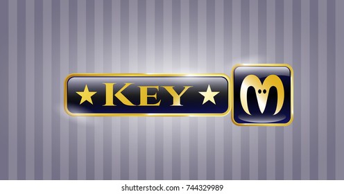  Gold badge or emblem with goat head icon and Key text inside