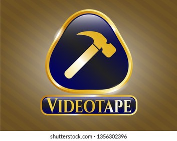  Gold badge or emblem with hammer icon and Videotape text inside