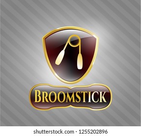  Gold badge or emblem with hand gripper icon and Broomstick text inside