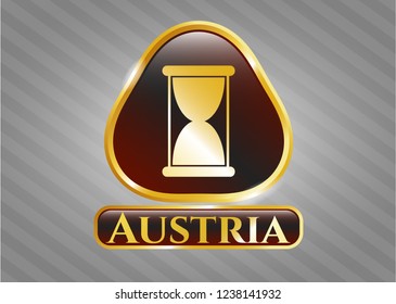  Gold badge or emblem with hourglass icon and Austria text inside