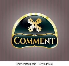  Gold badge or emblem with mechanism icon and Comment text inside