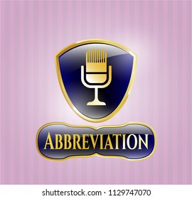  Gold badge or emblem with microphone icon and Abbreviation text inside