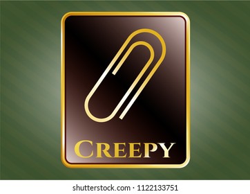  Gold badge or emblem with paper clip icon and Creepy text inside