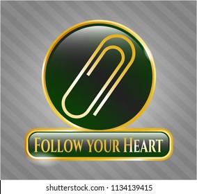  Gold badge or emblem with paper clip icon and Follow your Heart text inside
