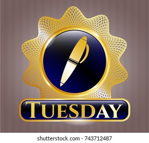  Gold badge or emblem with pen icon and Tuesday text inside