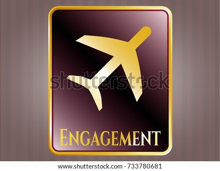  Gold badge or emblem with plane icon and Engagement text inside