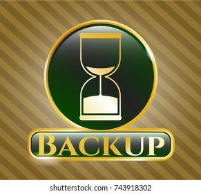  Gold badge or emblem with sand clock icon and Backup text inside