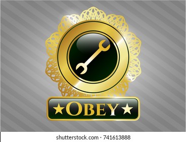  Gold badge or emblem with wrench icon and Obey text inside