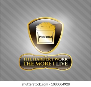   Gold badge with popcorn icon and The Hardest I work the More I Live text inside