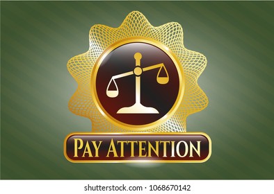    Gold badge with scale icon and Pay Attention text inside